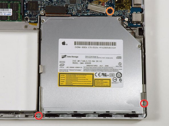 Image 1/1: Two 3.3 mm silver Phillips screws on either side of the SuperDrive.