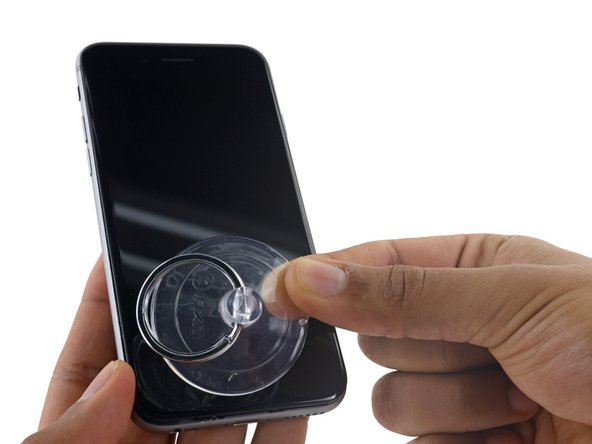 Pull up on the nub on the top side of the suction cup to remove it from the front panel.