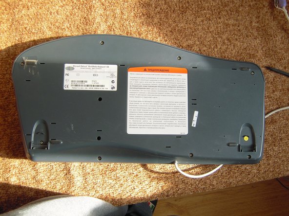 Image 1/3: Remove the upper button assembly.