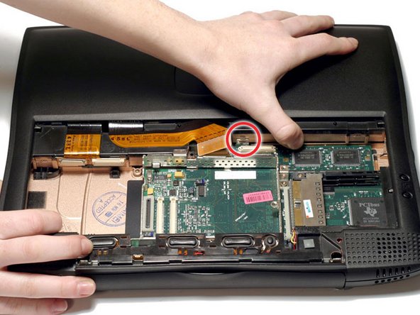 Image 1/1: Disengage the small locking tab by pressing in on the upper case to the right of the PMU connector.