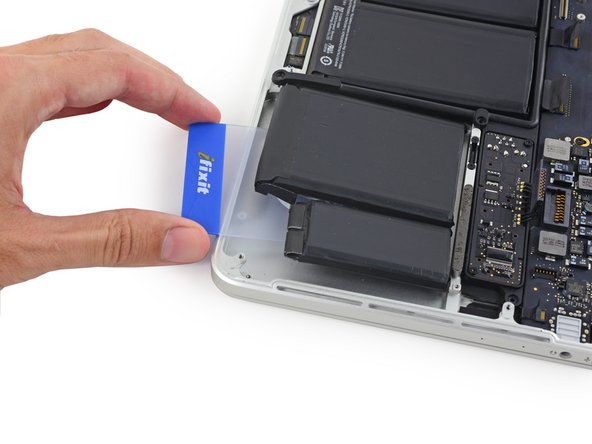 Image 1/3: Reheat the iOpener and reapply it, this time to the left-most battery cells.