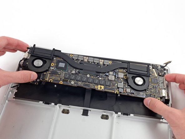 Image 1/2: Pull the right I/O port side of the logic board away from the side of the upper case and remove the logic board assembly.