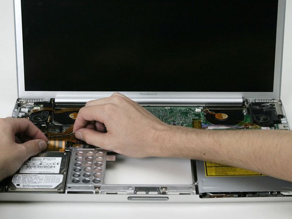 Image 1/1: Lift the hard drive and its attached cable out of the computer.