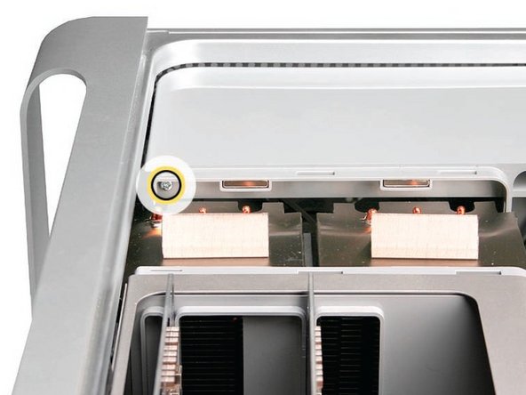 Image 3/3: Remove the second Phillips screw at the bottom front of the assembly.