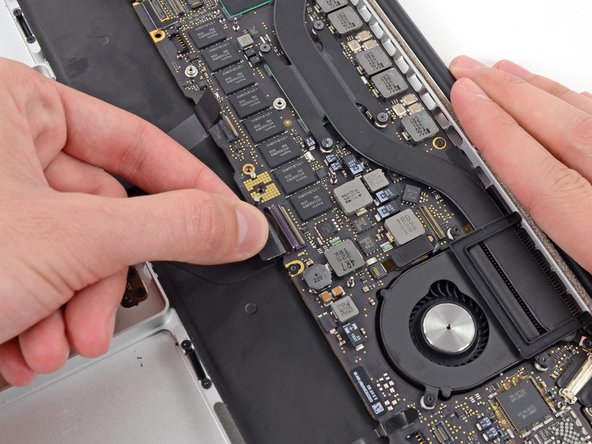 Image 3/3: Grasp the plastic pull tab and pull the keyboard ribbon cable out of its socket.