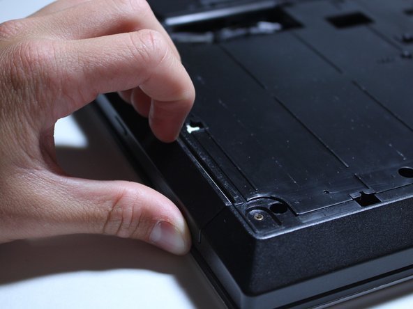 Stick your fingernails between the slight gap where the Optical Disk Drive slides out and the plastic frame of the computer.