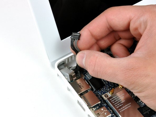 Image 1/1: Using your fingers, pull out the MagSafe board.