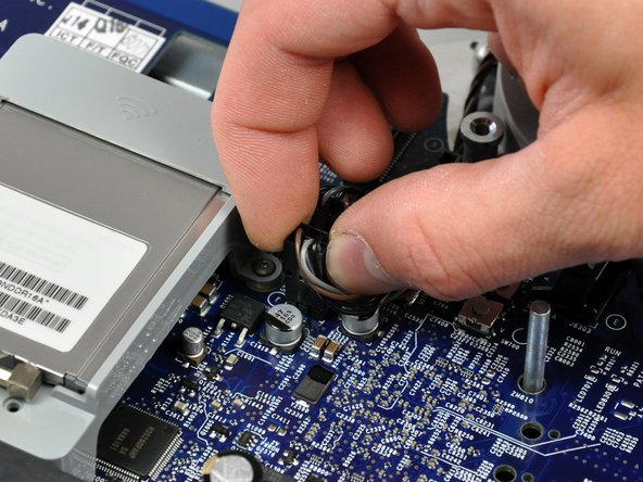 Image 1/2: The larger of the two fans connects closest to the top edge of the logic board.