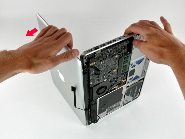 Image 2/3: Lift the display away from the upper case, minding any brackets or cables that may get caught.
