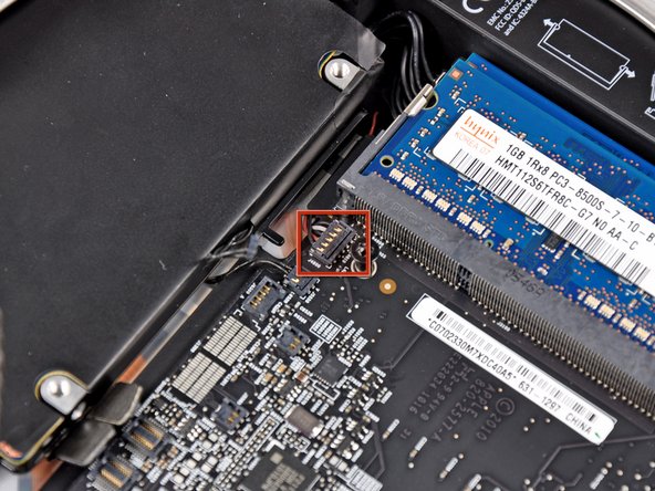 Image 3/3: Pull the I/O board/logic board assembly out of the outer case a maximum of 5 mm. Pulling the assembly out further may damage the IR sensor connector (highlighted in red in the third picture).