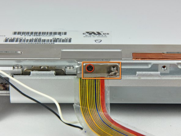 Image 1/1: Remove the small rectangular steel bracket by sliding it away from the right clutch hinge.