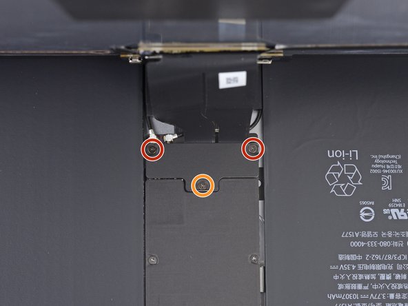 While supporting the display assembly, remove the following three Phillips screws over the display cable bracket.