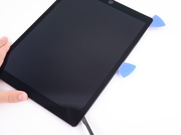 Cut the adhesive along the upper left side of the iPad towards the front-facing camera using the halberd spudger. This may require reheating the edge of the iPad.