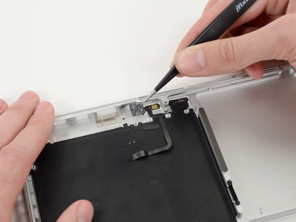 Image 3/3: Grasp the piece of tape with a pair of tweezers and remove it.