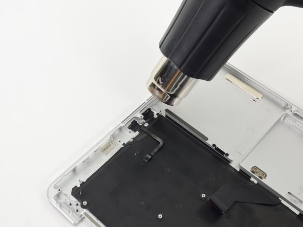 Image 1/1: With the heat gun set to low, heat the microphone assembly to loosen the adhesive attaching it to the upper case.