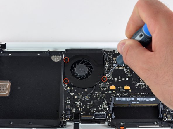 Image 1/2: After a few twists of a screwdriver and the flick of a spudger, the fan lifts right out.