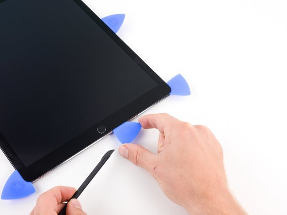 Insert the pick to the right of home button.