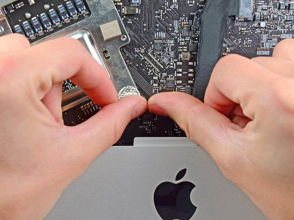 Image 1/2: Pull the IR sensor board up from behind the front face of the outer case.