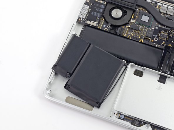 Image 3/3: Leave the battery cells resting on top of the upper case as highlighted in the third picture.