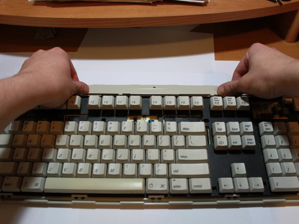 Image 3/3: Be sure to lift up and out, as there are five small sets of clips gripping the bottom.