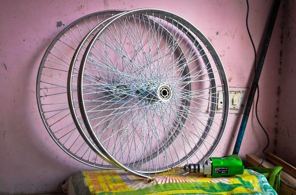 Pair of wheels at a Delhi rickshaw repair shop