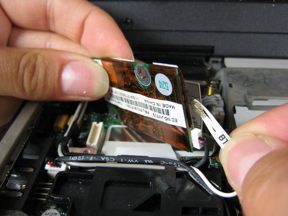 Image 1/2: Unplug the other cable that attaches the modem to the motherboard