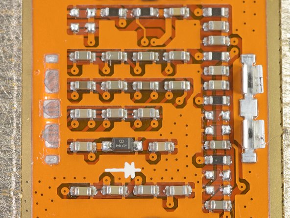 We also found a grid of what appears to be a smörgåsbord of capacitors, resistors (and one lonely diode) under the frame. Interesting...