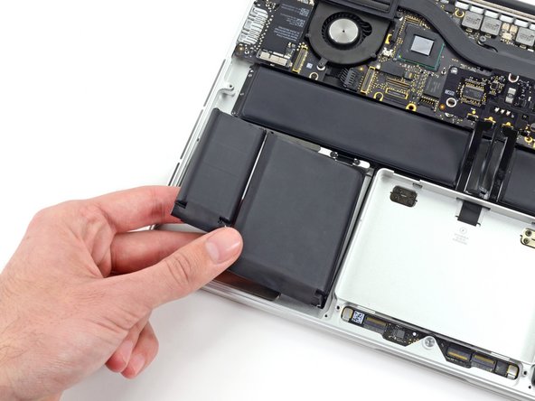 Image 1/3: Leave the battery cells resting on top of the upper case as highlighted in the third picture.