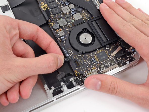 Image 3/3: Grasp the plastic pull tab and pull the microphone ribbon cable out of its socket.