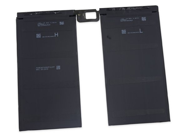 Image 3/3: In addition to some obscure markings, the underside of the battery still bears the anchoring strips(?) for the adhesive pull tabs.