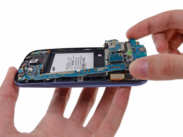 Image 2/2: Remove the motherboard assembly from the front panel assembly, minding any cables that may snag on it.