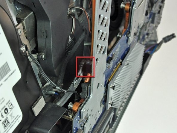 Image 1/2: Insert the blunt end of a metal spudger between the SATA connector and its socket. Twist the shaft of the metal spudger to separate the connector from its socket.