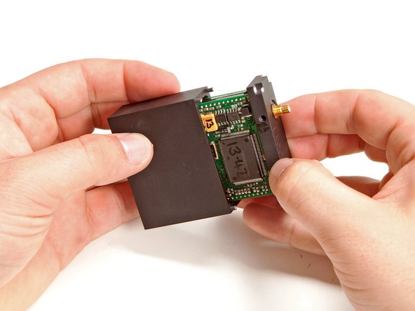 Image 1/3: Upon successfully drilling out all the screw heads, the outer case slides right off the transmitter/receiver assembly.