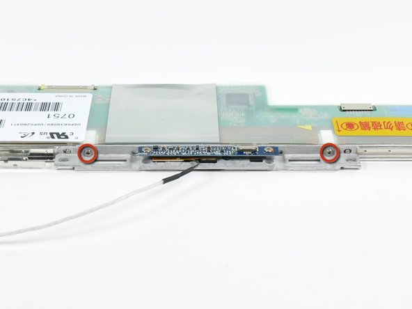 Remove the two 3.1 mm Phillips screws securing the iSight holder to the top of the display.