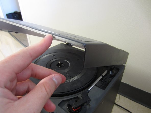 Open the lid to access the turntable, arm, and stylus.