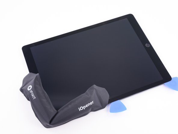 Lay a hot iOpener along the upper left corner of the iPad, spanning from the opening pick to the front-facing camera.