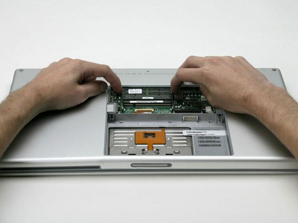 Image 1/1: Pull the chip directly out from its connectors. If there is a second RAM chip installed, pop it out in the same manner.