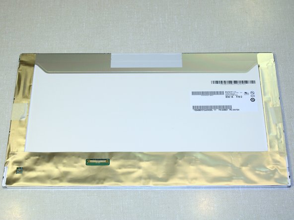 Image 1/3: A protective sheet is taped to the front of the display. Leave it on until we are almost done installing the display in the laptop.