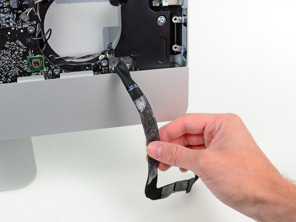 Image 2/2: Peel the audio port cable off the front face of the logic board and let it hang down as shown in the second picture.