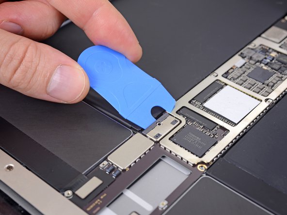 The battery blocker is an outdated way of isolating the battery, as you risk damaging the battery pins underneath the logic board. If you use this method, take extreme care to insert it gently and straight in the direction of the logic board. Don't significantly deform the the logic board as you do this. Don't twist or swing the pick side to side.