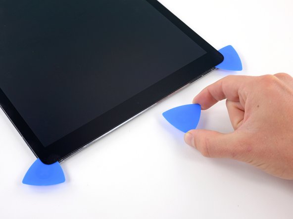 Remove the pick that was placed in the middle of the top edge of the iPad, next to the front-facing camera.