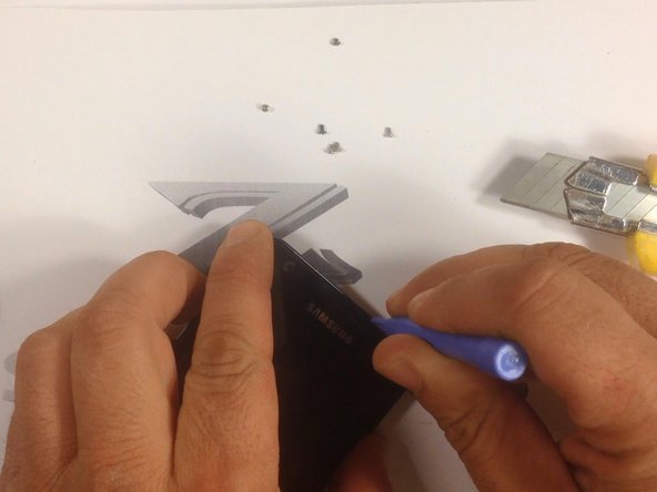 With a cutter, make a room for a plastic tool, then continue with separating the Touchscreen &amp; LCD Display from the frame.