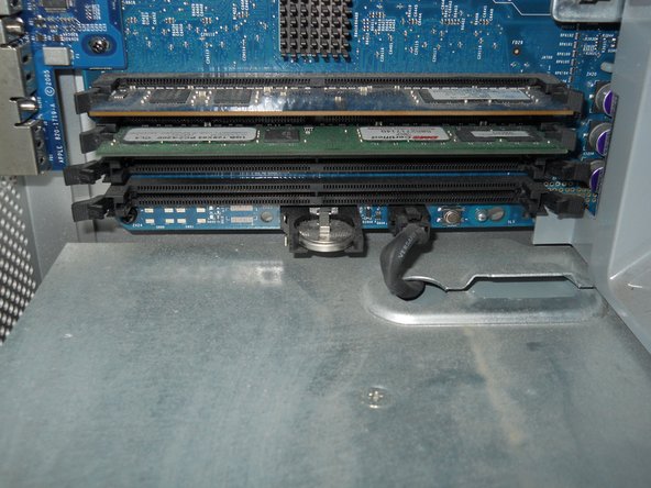 Image 1/2: to get the battery out, put your thumb under the battery, and push up while pulling the battery away from the motherboard (couldn't get a good picture of this)