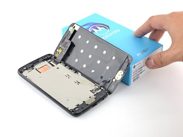 Swing open the screen and prop it up with a small box as you work on disconnecting the flex cables.