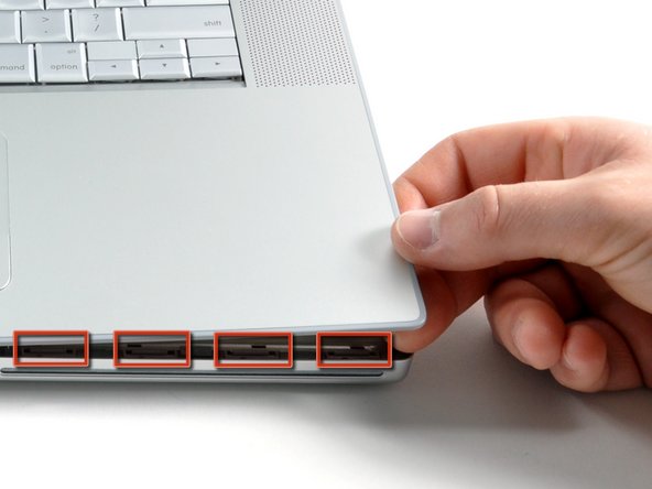 Image 2/3: There are four plastic clips above the DVD slot, and another above and to the left of the IR sensor.  These clips can be very difficult to disengage without prying.  They can also be difficult to re-engage during reassembly.