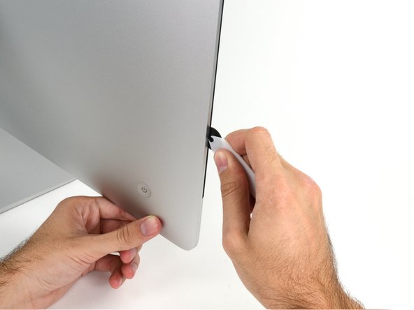 Image 2/3: Run the tool up along the left side of the display.