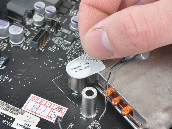 Image 1/3: After popping off the CPU heat sink, we can get a good look at the Core i5 processor.