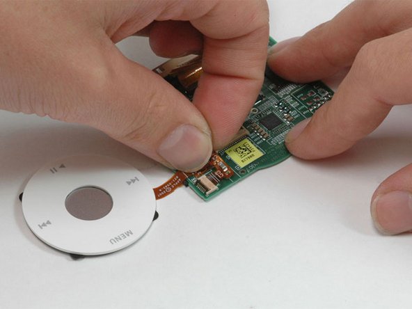 Image 1/1: Lift the click wheel assembly away from the logic board.