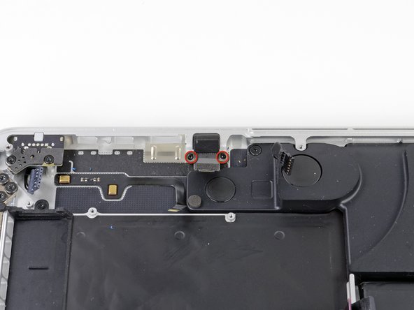Image 1/2: Slide the headphone jack away from the upper case.