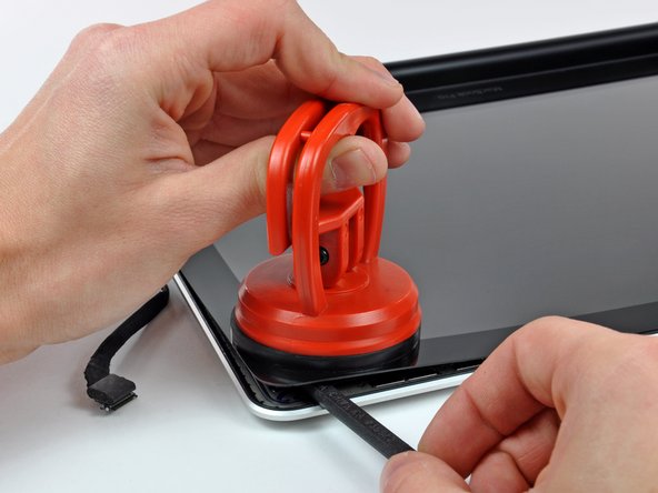 Image 3/3: Pry up the glass panel a few inches away from the upper right corner along the top and right edges of the display.